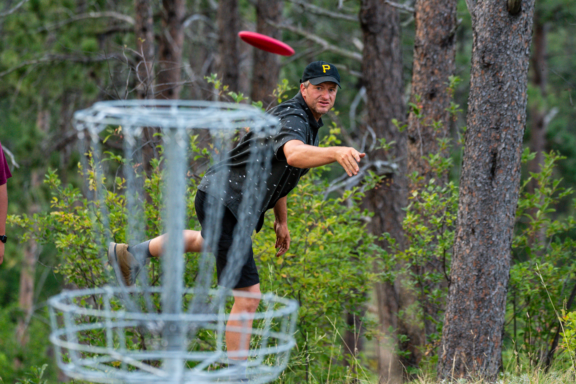 Zane Hesting watches his disc fly to the basket at Chadron State Park.