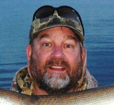 Angler with sunglasses on head.