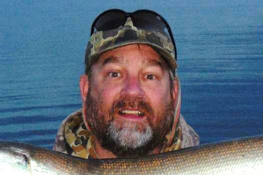 Angler with sunglasses on head.