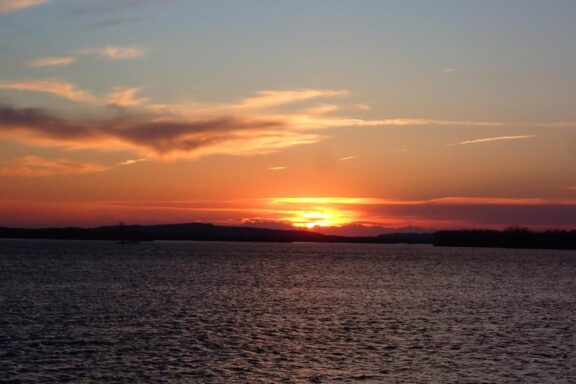 A sun sets over a lake in Nebraska during spring.