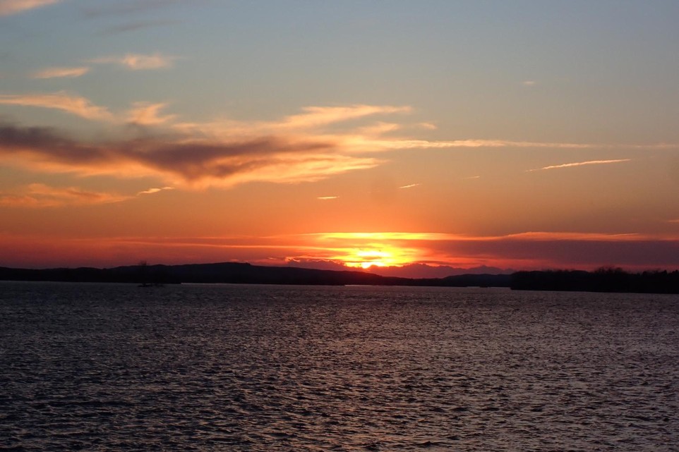 A sun sets over a lake in Nebraska during spring.