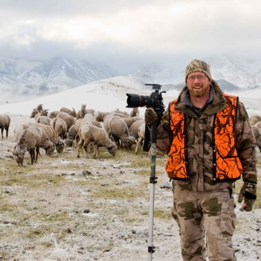 Photographer Eric Fowler during a bighorn sheep capture operation in Alberta, Canada.