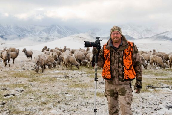 Photographer Eric Fowler during a bighorn sheep capture operation in Alberta, Canada.