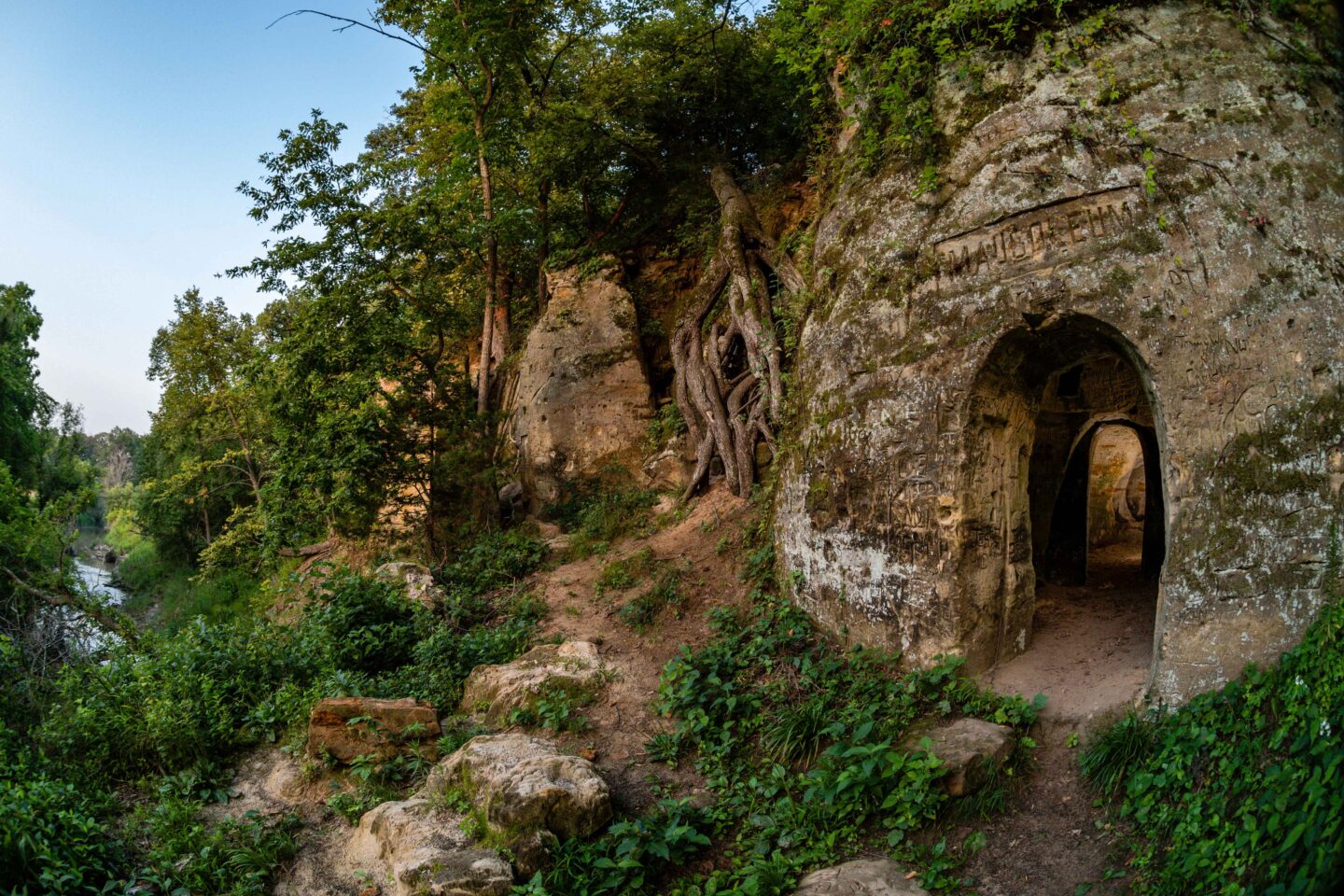 An arched doorway marks the entrance to McDowellβs Tomb in the cliff at Rose Creek Wildlife Management Area in Jefferson County.