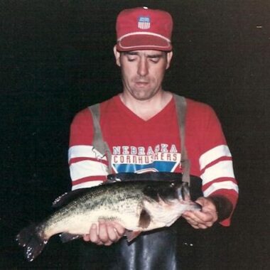 Angler holding a largemouth bass.
