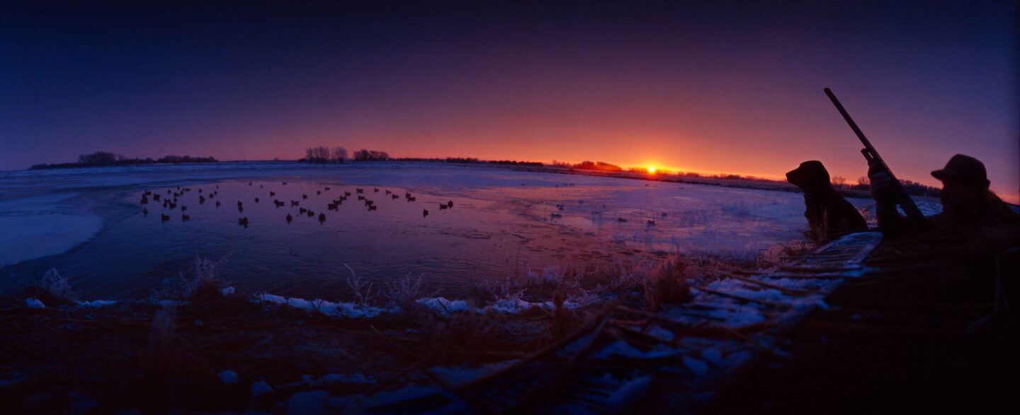 Don Cunningham used a 35mm panoramic camera to shoot this image of duck hunters at sunrise.