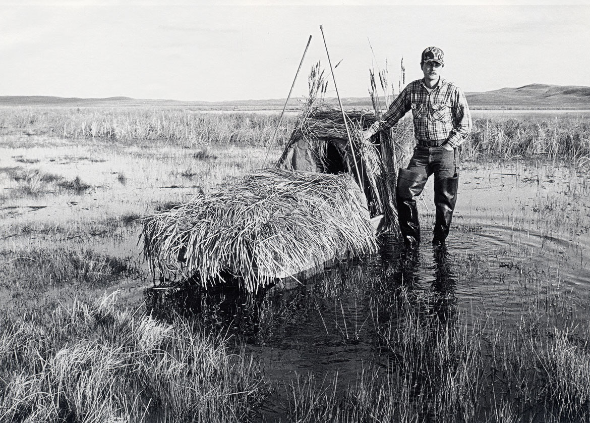  Jon Farrar, pictured here in 1981, spent countless hours photographing wildlife from a variety of blinds, including this one he built from conduit and chicken wire to fit on his johnboat, during his 42 years with Nebraskaland.