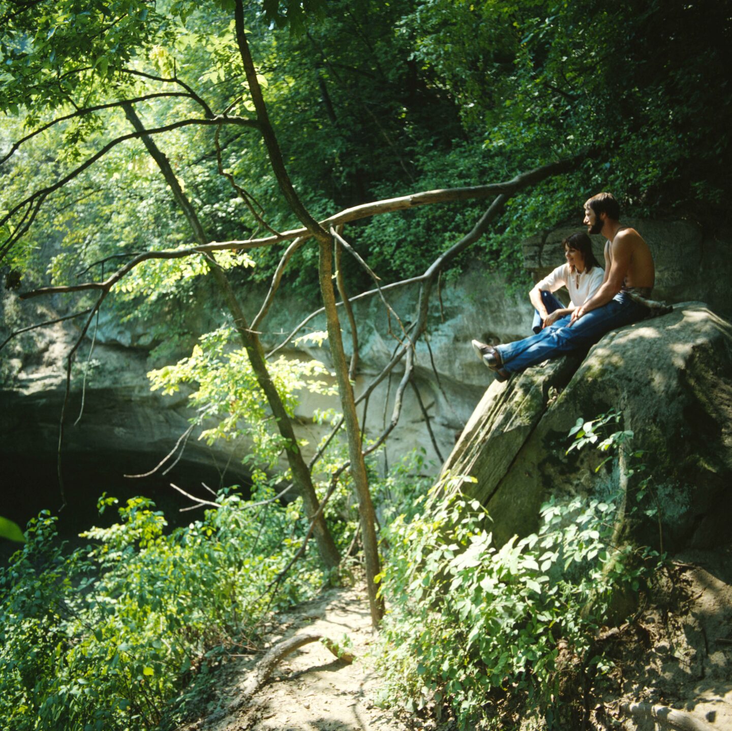 David and Kirsten Vogt sit above the cave opening in 1981.  