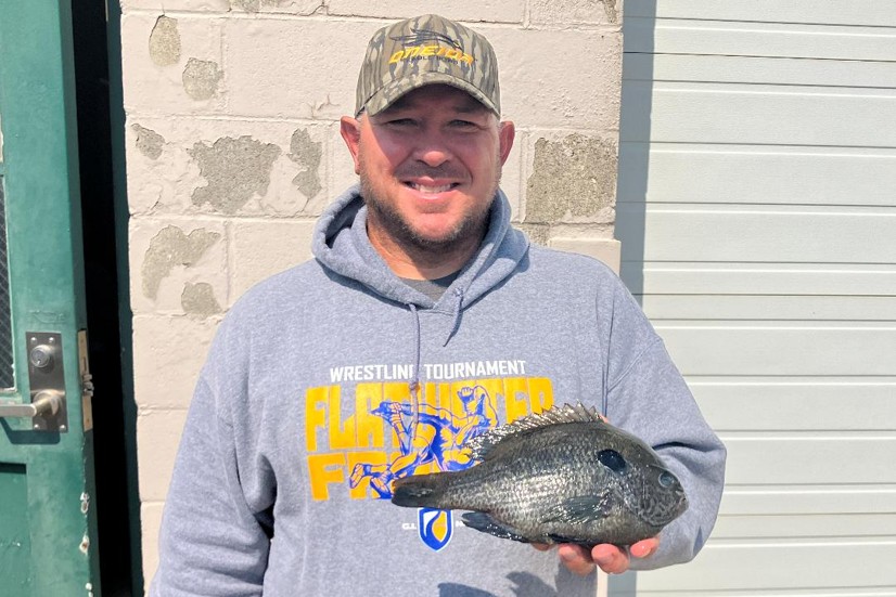 Angler holding hybrid sunfish. Nebraska Game & Parks Commission.