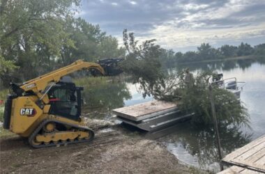 Cut cedar trees being placed on barge at Bridgeport SRA. Photo by Nebraska Game & Parks Commission.