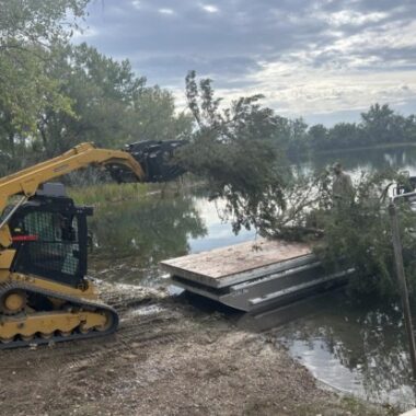 Cut cedar trees being placed on barge at Bridgeport SRA. Photo by Nebraska Game & Parks Commission.