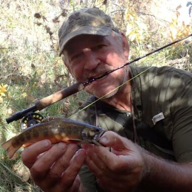 Angler holding brook trout caught on fly rod. Photo by Daryl Bauer, Nebraska Game & Parks Commission.
