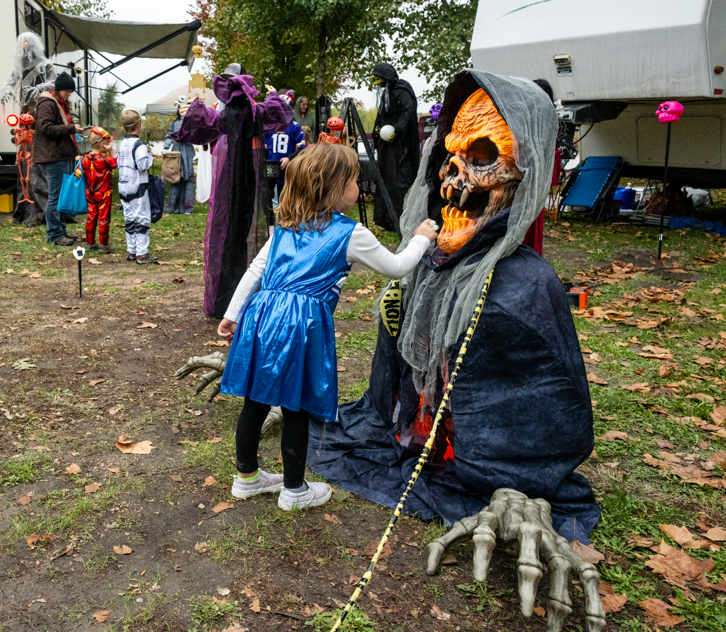 A young trick-or-treater gets an up-close look at an animatronic ghoul gracing a campsite at Alexandria SRA.