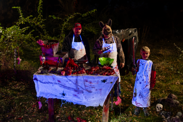 Daniel Durflinger and Brent and Layne Wolfe man their butcher’s table along the haunted walk through the woods.