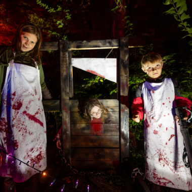 Lorna Thomas, Addison Paul and Layne Wolfe man a guillotine along a haunted walk through the woods in the west campground during the annual Camp Spook Halloween event at Alexandria State Recreation Area.