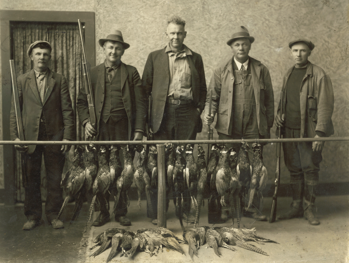 Will Stricker, left, poses with four other hunters, unknown, in the Frederick Hotel in Loup City during one of Nebraska’s first pheasant seasons. Photo courtesy of Larry Jones